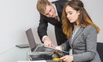 two-businesspeople-having-discussion-document