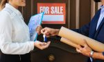 woman-receiving-key-from-real-estate-agent