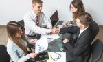 elevated-view-businessman-shaking-hands-with-his-partner-workplace