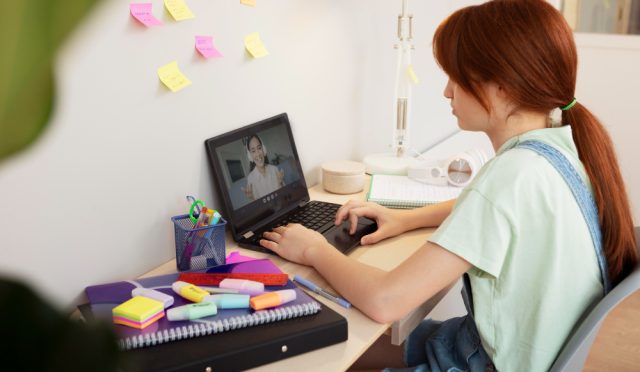 medium-shot-girl-typing-home