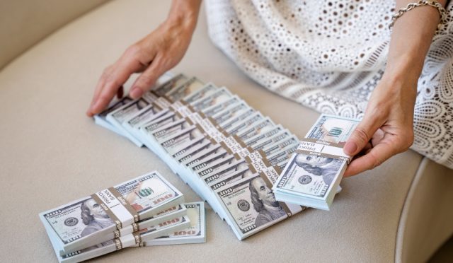 portrait-middle-aged-blonde-rich-woman-with-banknotes